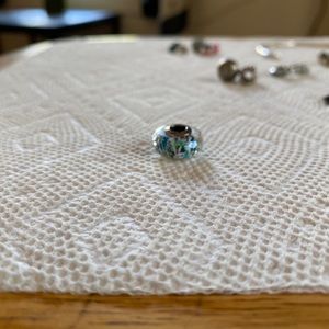 Pandora glass charm with blue, green and white insert.